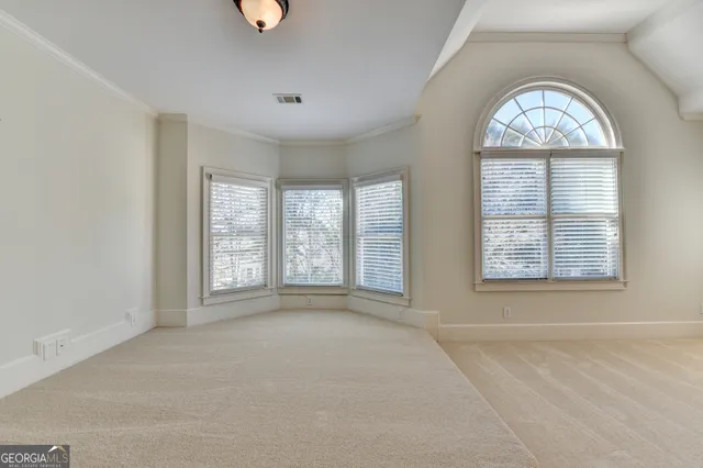 a view of a room with rack on the wall and a window