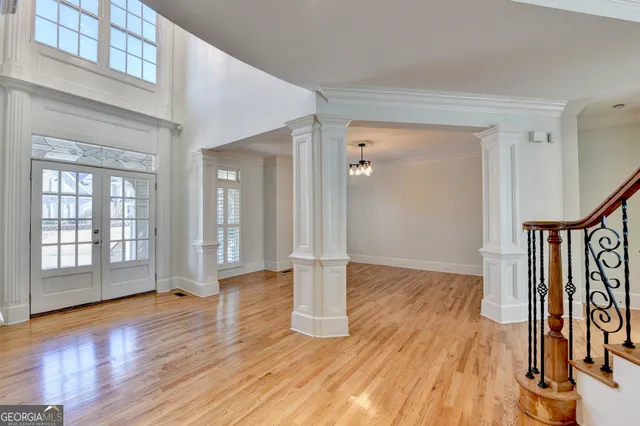 a view of staircase with wooden floor and a chandelier