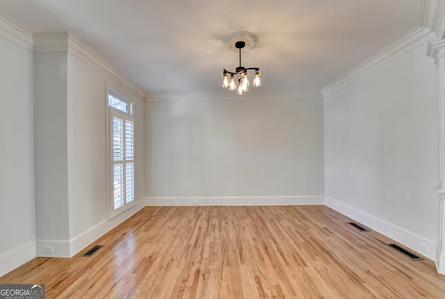 a view of an empty room with a fireplace and a window