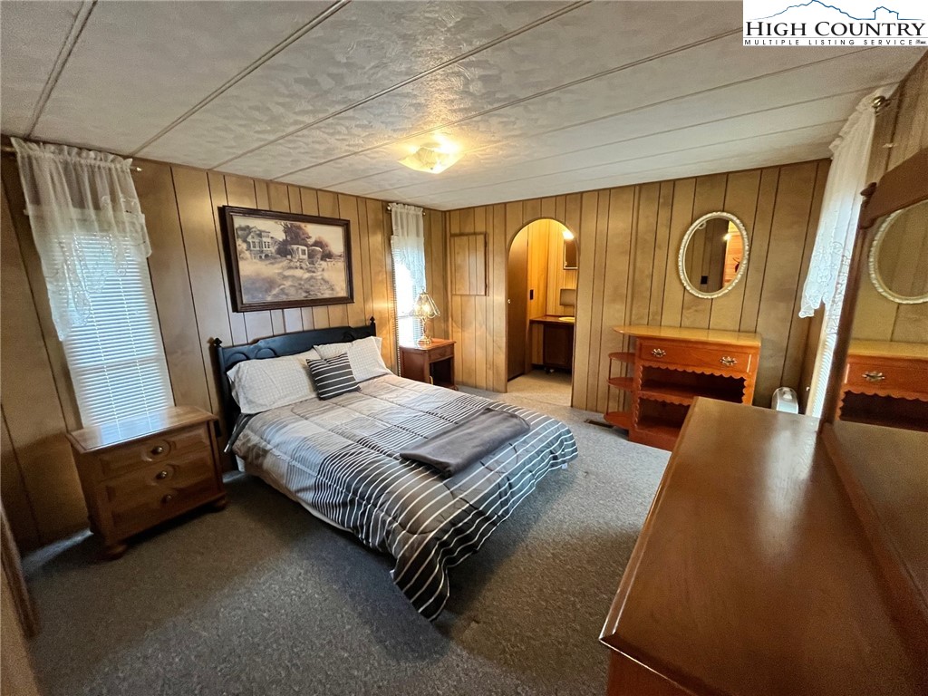 164 Smith Road Deep Gap, NC 28618 - Photo 13 of 16 a bedroom with a bed and a mirror