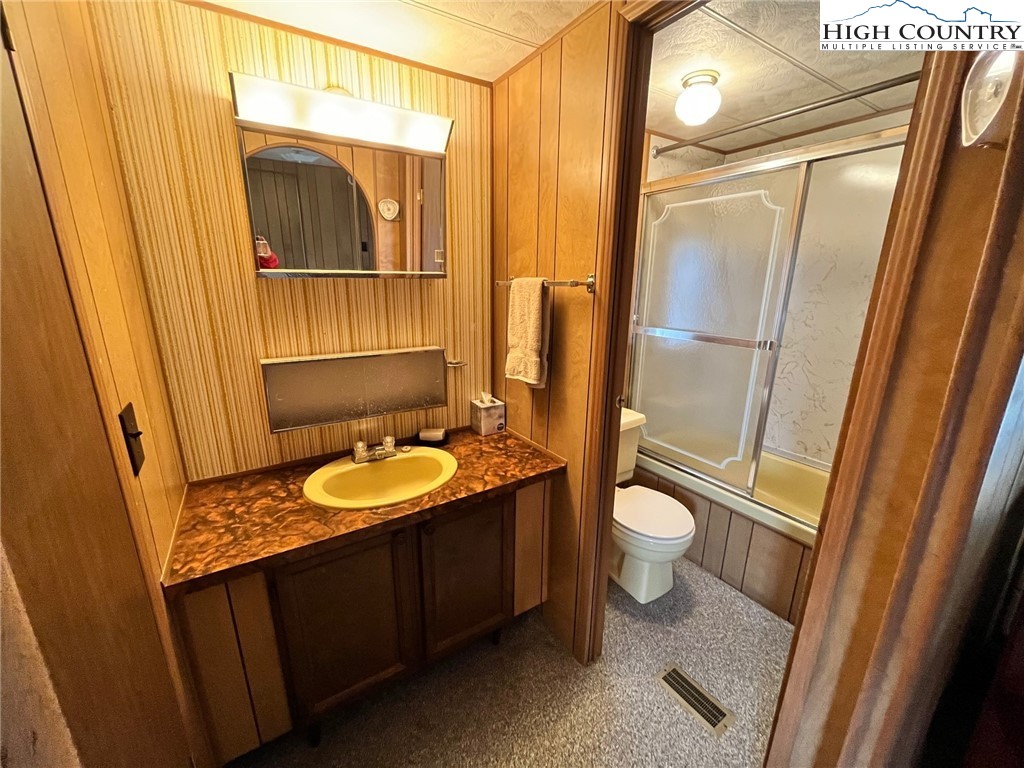 164 Smith Road Deep Gap, NC 28618 - Photo 14 of 16 a bathroom with a granite countertop sink toilet and shower