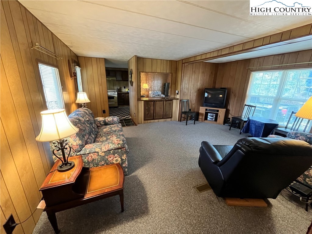 164 Smith Road Deep Gap, NC 28618 - Photo 7 of 16 a living room with furniture a large window and gym equipment
