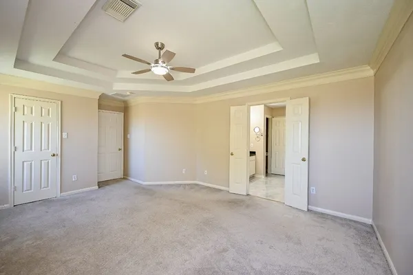 an empty room with fan and entryway