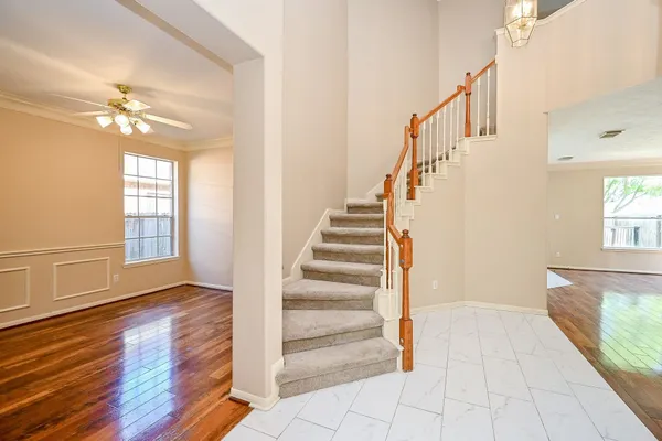 a view of entryway and hall with wooden floor