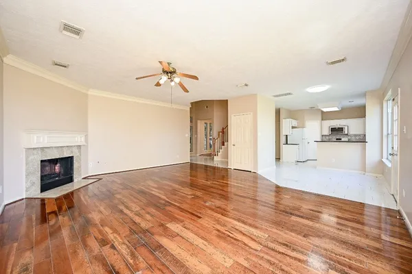 a view of kitchen and hall with wooden floor