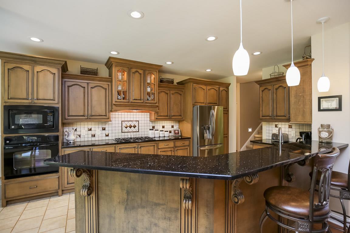 223 Butler Bridge Road Portland, TN 37148 - Photo 12 of 30 a kitchen with kitchen island granite countertop a stove cabinets and chairs