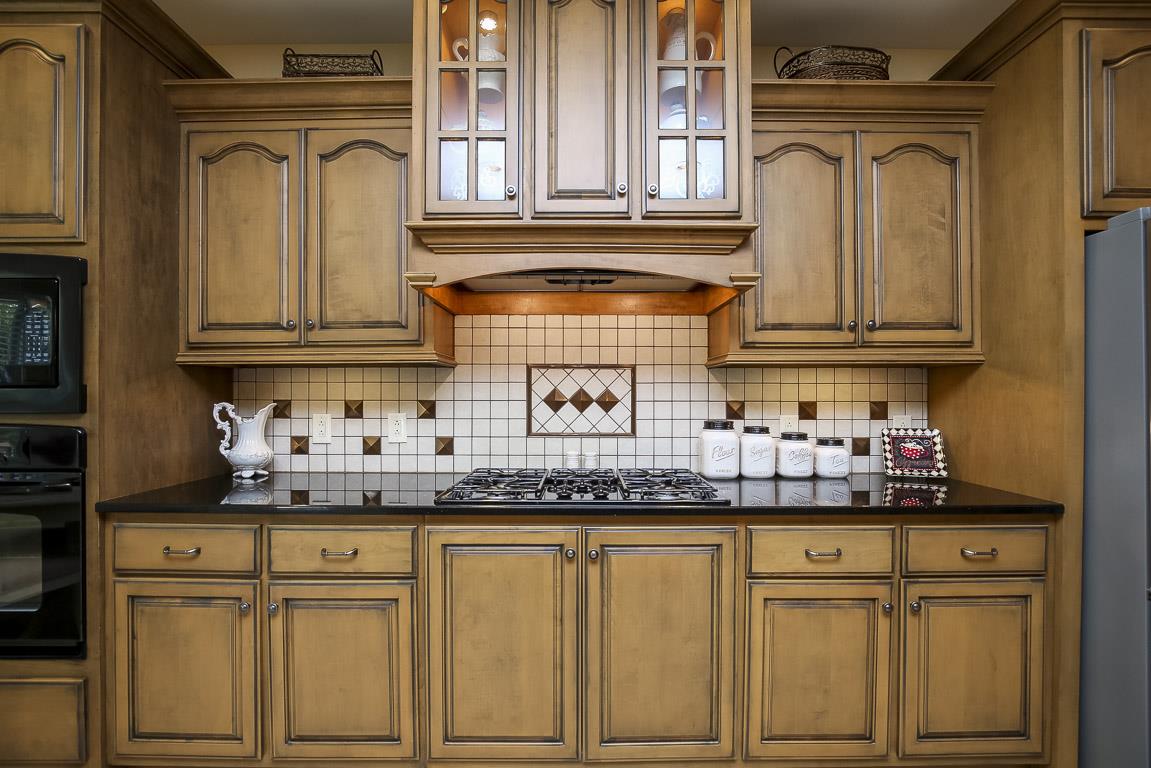 223 Butler Bridge Road Portland, TN 37148 - Photo 13 of 30 a kitchen with granite countertop white cabinets and a sink