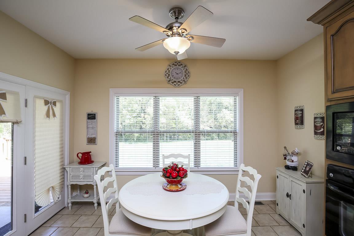 223 Butler Bridge Road Portland, TN 37148 - Photo 16 of 30 a dining room with furniture a chandelier and window