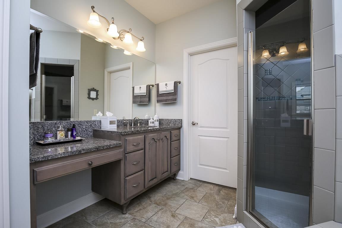 223 Butler Bridge Road Portland, TN 37148 - Photo 20 of 30 a spacious bathroom with a granite countertop sink a mirror and shower
