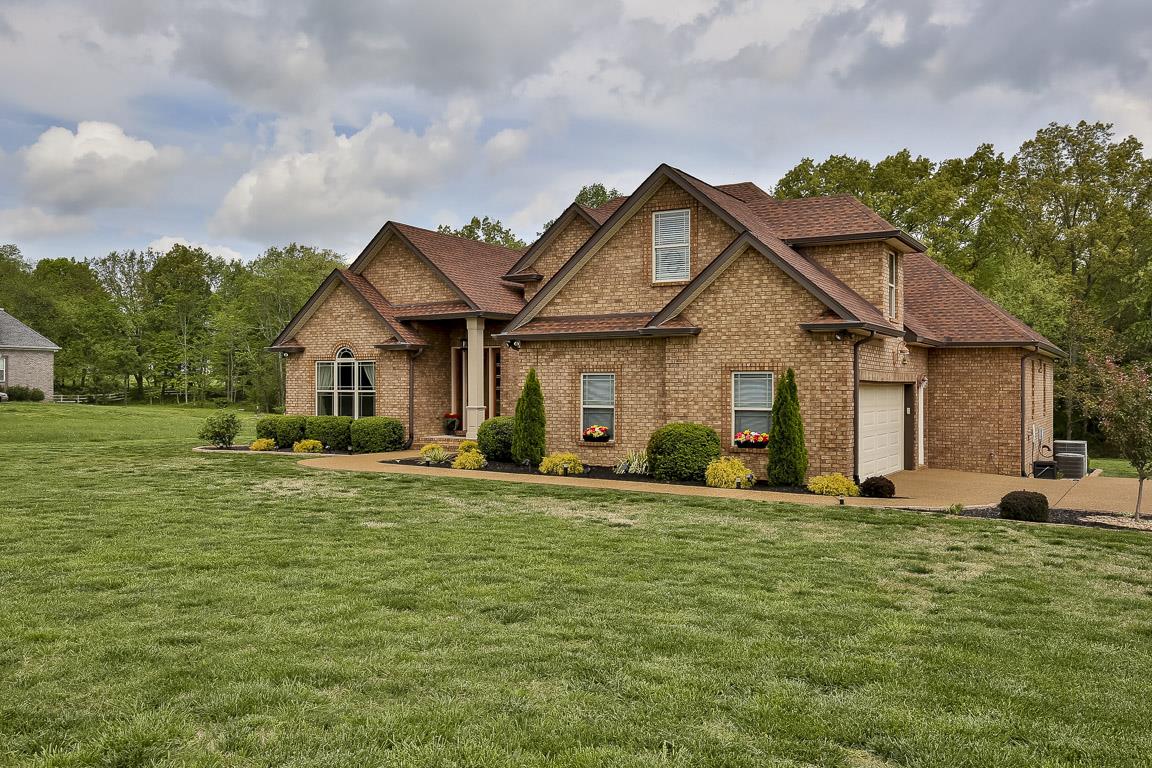 223 Butler Bridge Road Portland, TN 37148 - Photo 2 of 30 a front view of a house with a garden and trees