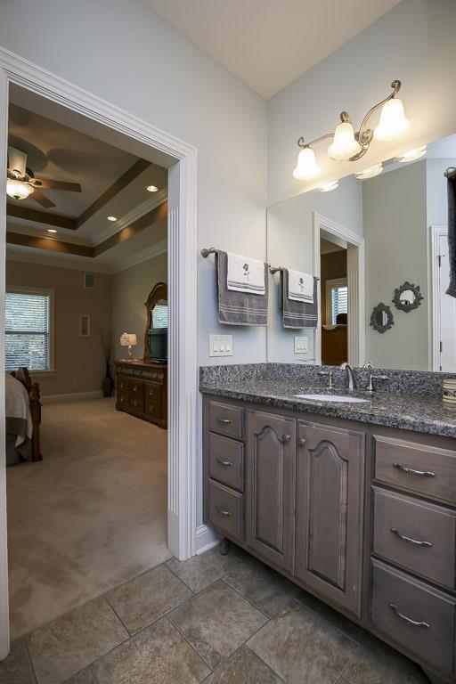 223 Butler Bridge Road Portland, TN 37148 - Photo 21 of 30 a bathroom with a granite countertop sink a large mirror and a shower