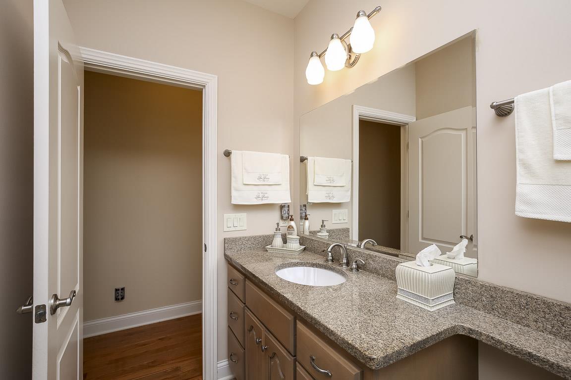 223 Butler Bridge Road Portland, TN 37148 - Photo 25 of 30 a bathroom with a granite countertop sink and a mirror
