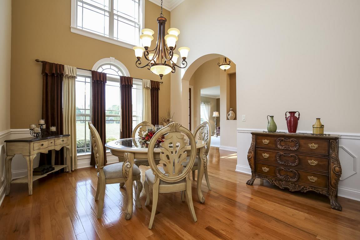223 Butler Bridge Road Portland, TN 37148 - Photo 8 of 30 a view of a dining room with furniture chandelier and wooden floor