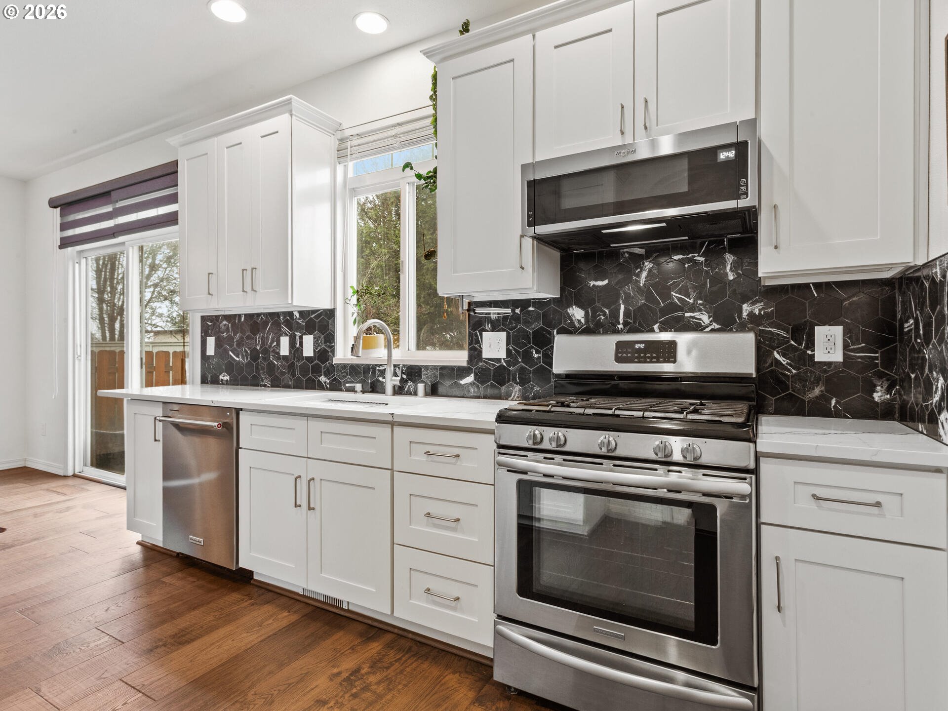 19200 Southeast 33rd Circle Camas, WA 98607 - Photo 12 of 43 a kitchen with stainless steel appliances granite countertop a stove a cabinets and a wooden floor