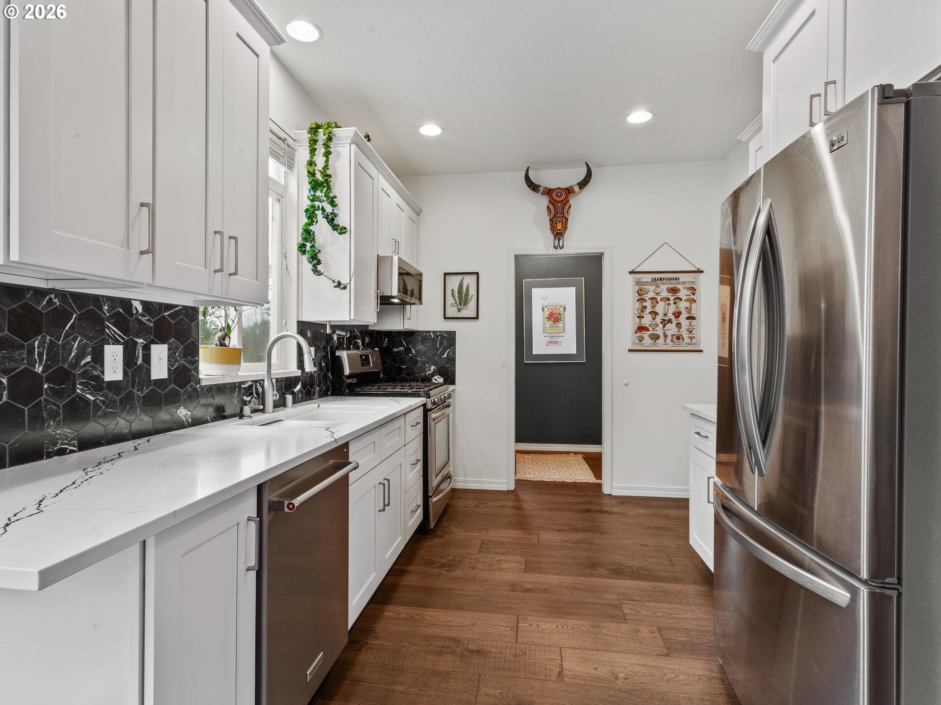 19200 Southeast 33rd Circle Camas, WA 98607 - Photo 10 of 43 a kitchen with stainless steel appliances granite countertop a refrigerator a sink and white cabinets