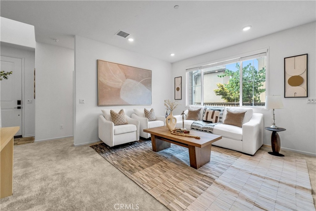 5584 Kate Way, Unit 10 Fontana, CA 92336 - Photo 2 of 42 a living room with furniture and a large window