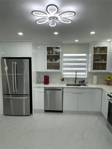 a kitchen with a refrigerator and a sink