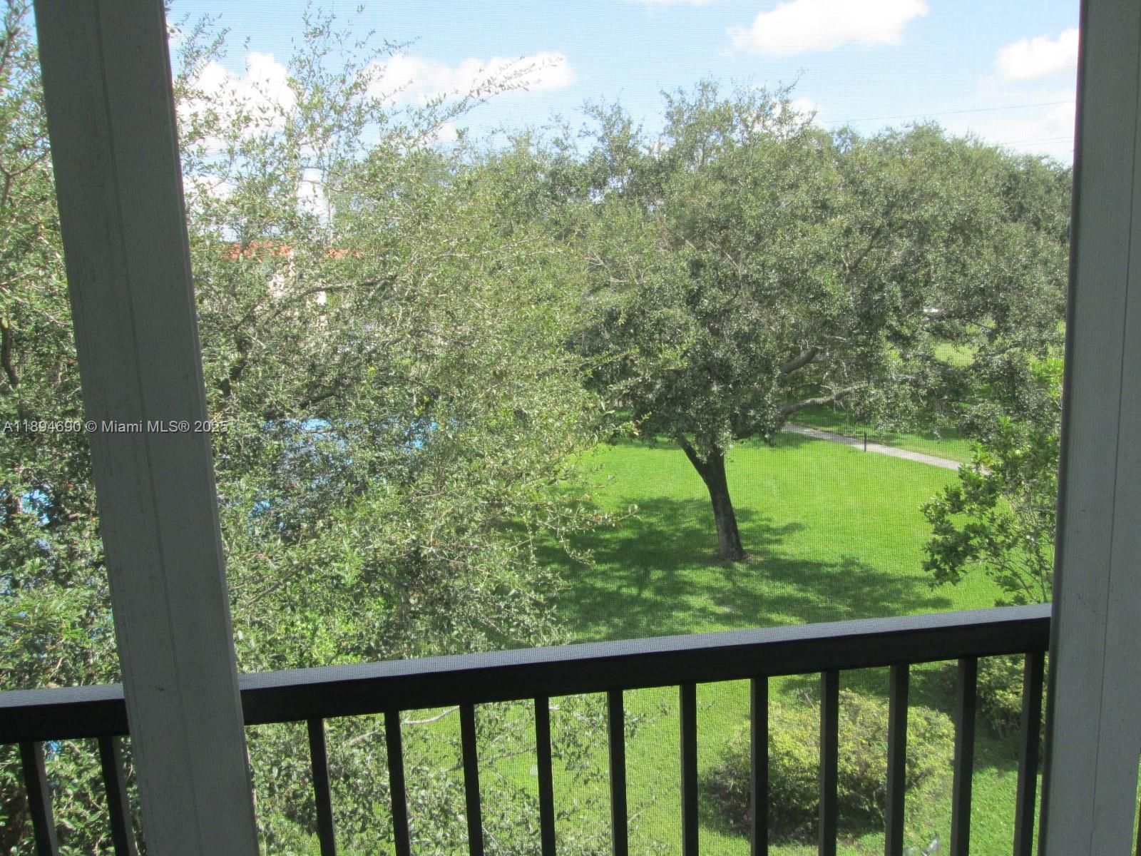 150 South Hollybrook Terrace, Unit 303 Pembroke Pines, FL 33025 - Photo 14 of 18 a view of outdoor space and trees
