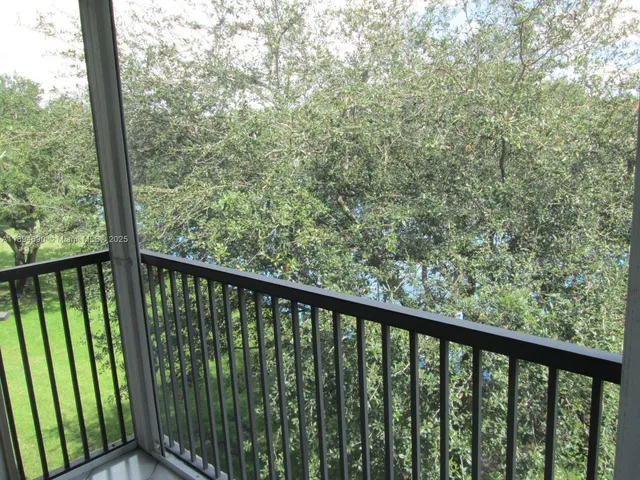 a view of a balcony with wooden floor