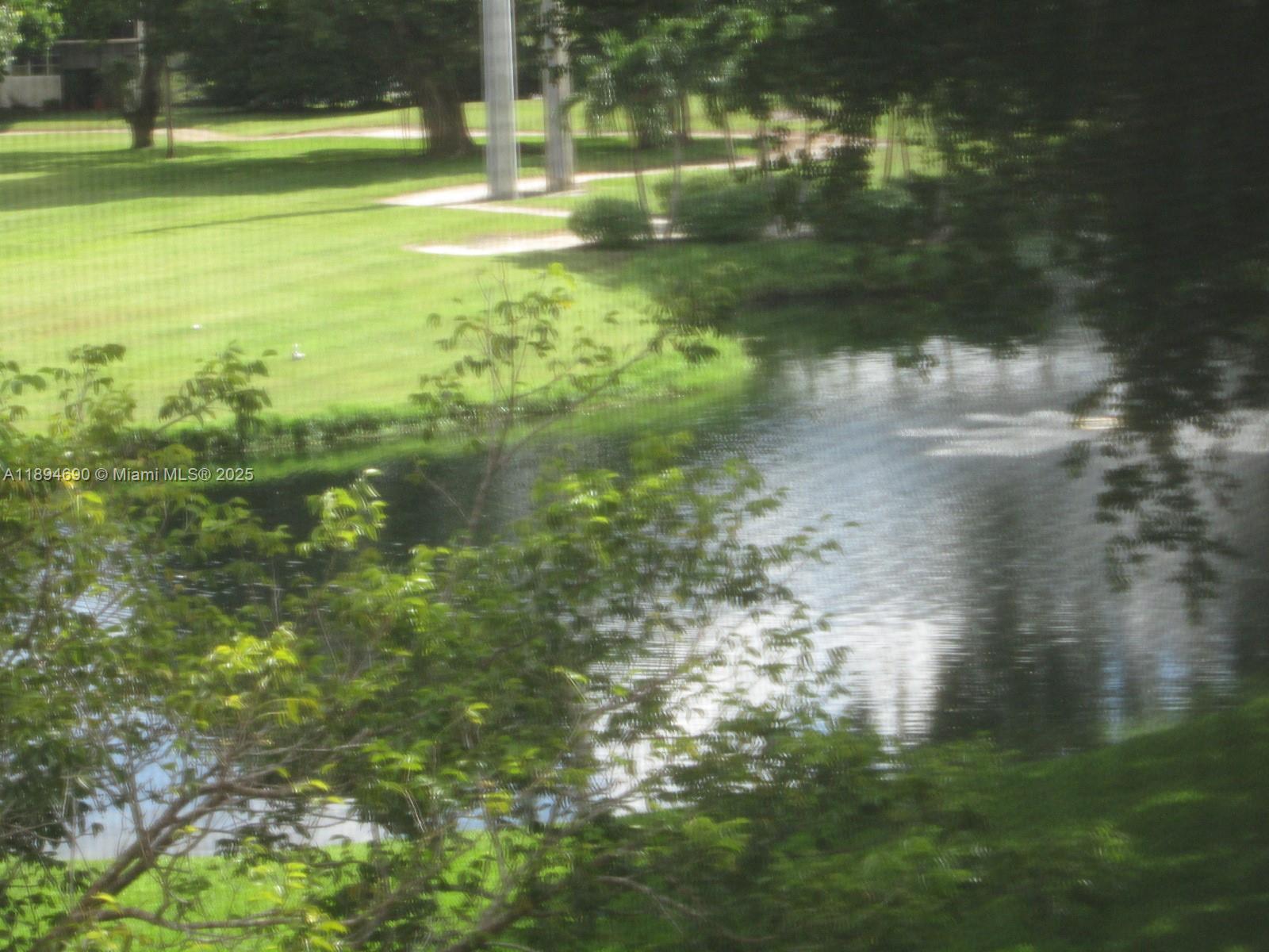 150 South Hollybrook Terrace, Unit 303 Pembroke Pines, FL 33025 - Photo 17 of 18 a backyard of a house with lots of green space and lake view