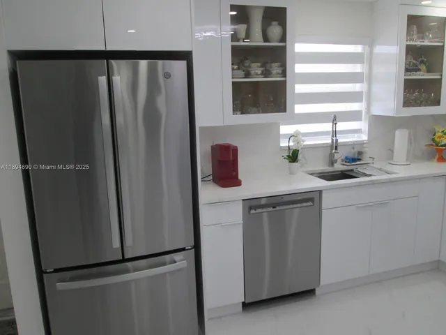 a kitchen with a refrigerator and a sink