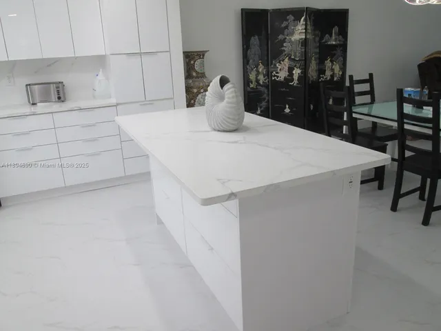 a kitchen with a table and chairs