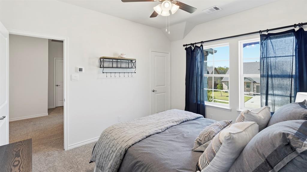 4197 Waldron Trail Forney, TX 75126 - Photo 22 of 25 Vaulted ceilings with a ceiling fan, dual windows, plush carpeting, and light-toned wall finishes