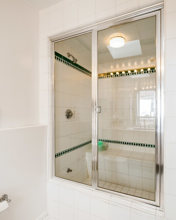 103 Appleton Street, Unit 4 Boston, MA 02116 - Photo 17 of 29 a bathroom with a glass shower door and a bathtub