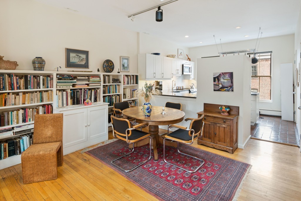 103 Appleton Street, Unit 4 Boston, MA 02116 - Photo 9 of 29 a living room with furniture a rug and a book shelf