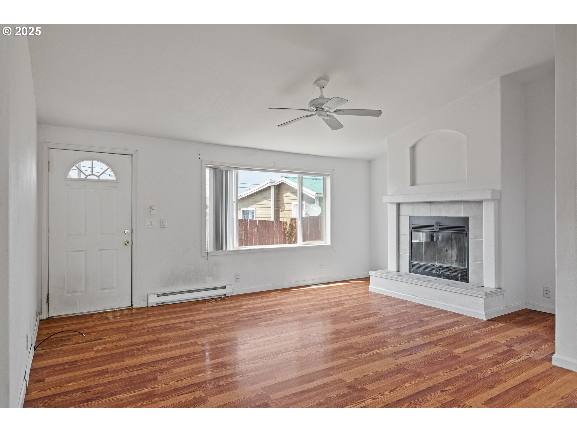 1829 East Willow Street Myrtle Point, OR 97458 - Photo 14 of 37 a view of an empty room with window and wooden floor