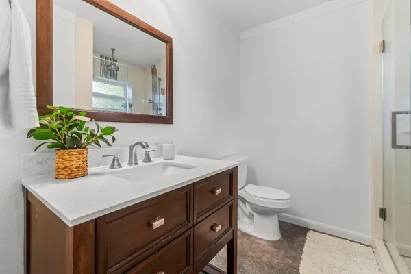 a bathroom with a sink vanity and a toilet