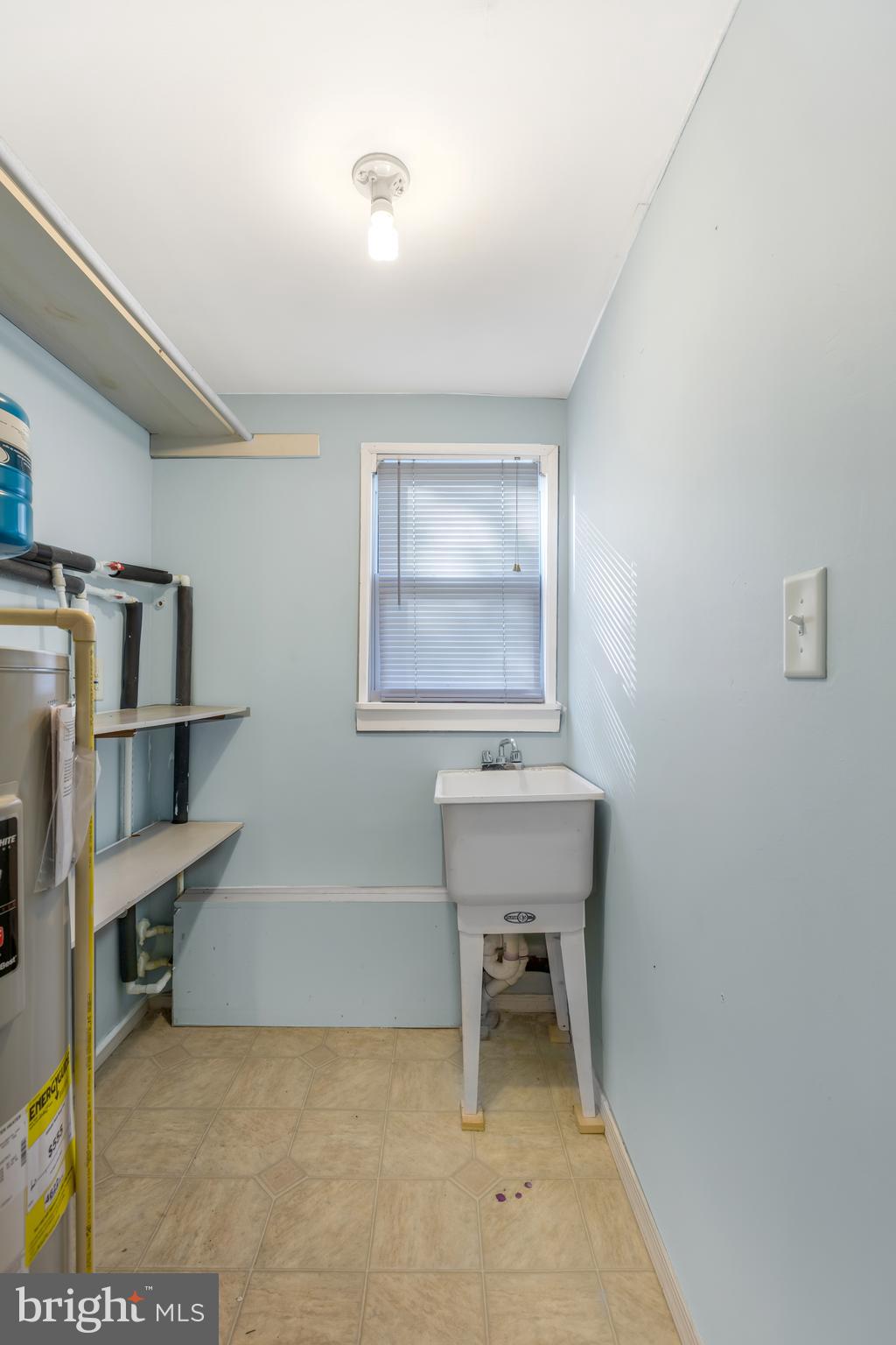 207 Brookfield Road Pasadena, MD 21122 - Photo 41 of 45 Utility room with water heater