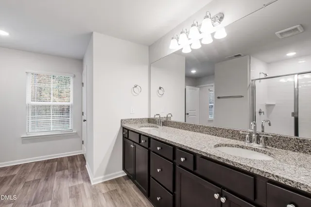 a bathroom with a granite countertop sink a large mirror and vanity