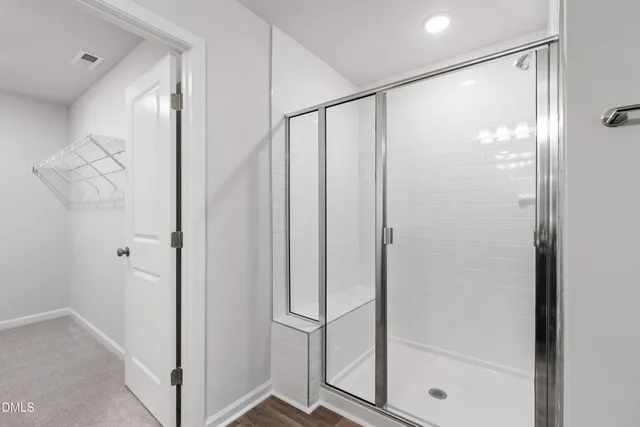 a bathroom with a glass shower door