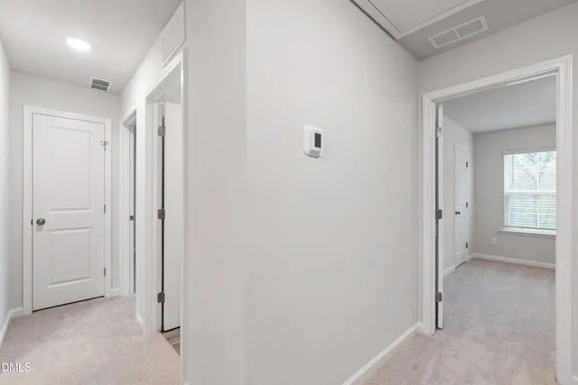 a view of a hallway with closet and wooden floor