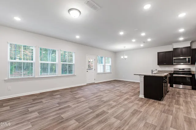 a view of kitchen with microwave and wooden floor