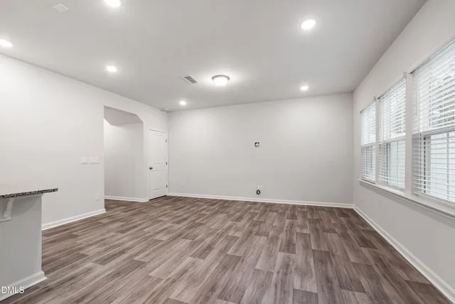 a view of room with window and wooden floor