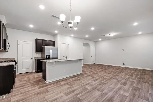 a view of a kitchen with a sink stainless steel appliances and cabinets