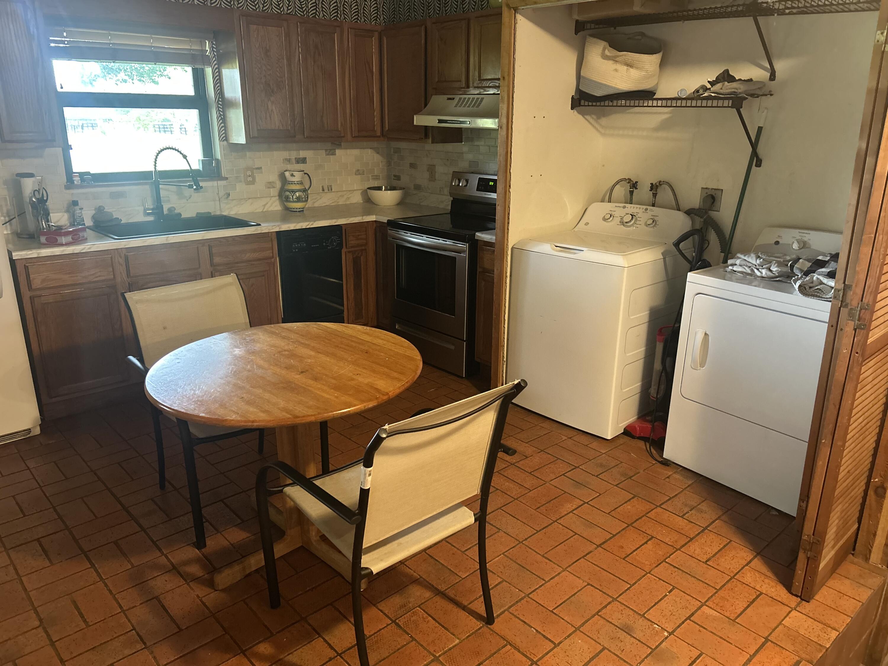 13821 53rd Road South Wellington, FL 33449 - Photo 7 of 10 a kitchen with a sink cabinets and window