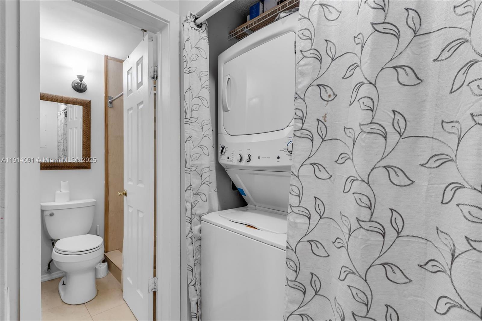 10930 Southwest 75th Street Miami, FL 33173 - Photo 15 of 34 a bathroom with a toilet and a shower curtain