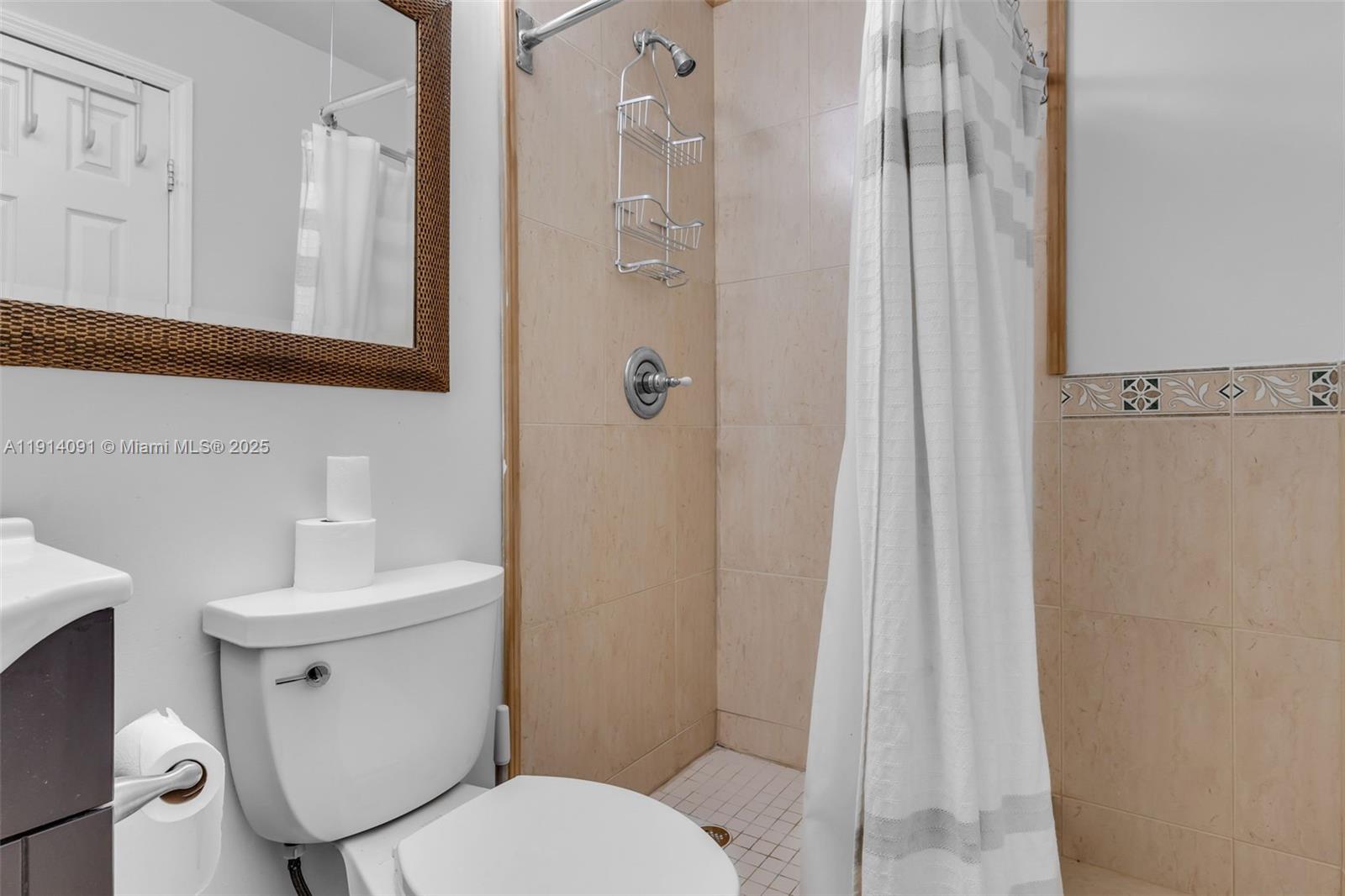 10930 Southwest 75th Street Miami, FL 33173 - Photo 16 of 34 a white toilet sitting next to a bathroom sink