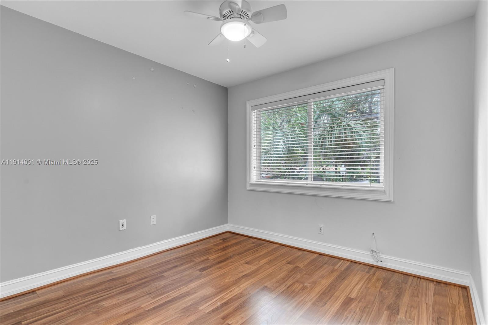 10930 Southwest 75th Street Miami, FL 33173 - Photo 18 of 34 a view of an empty room with wooden floor and a window