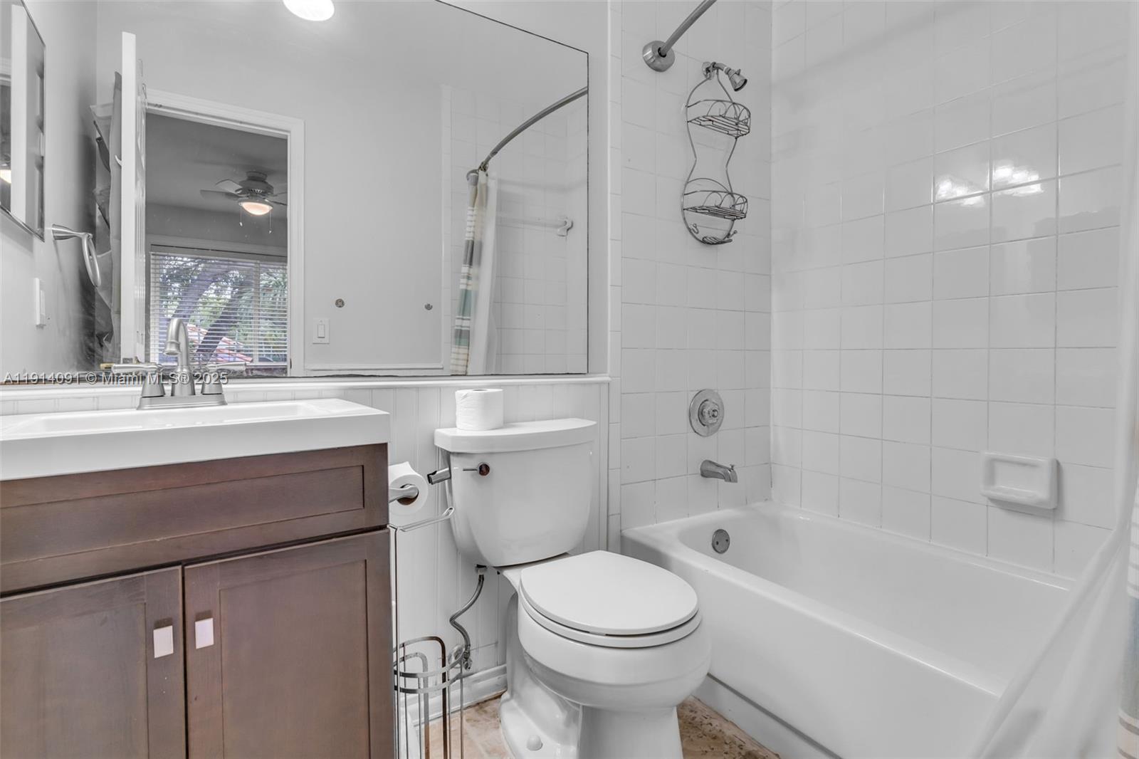 10930 Southwest 75th Street Miami, FL 33173 - Photo 20 of 34 a bathroom with a sink a toilet and shower