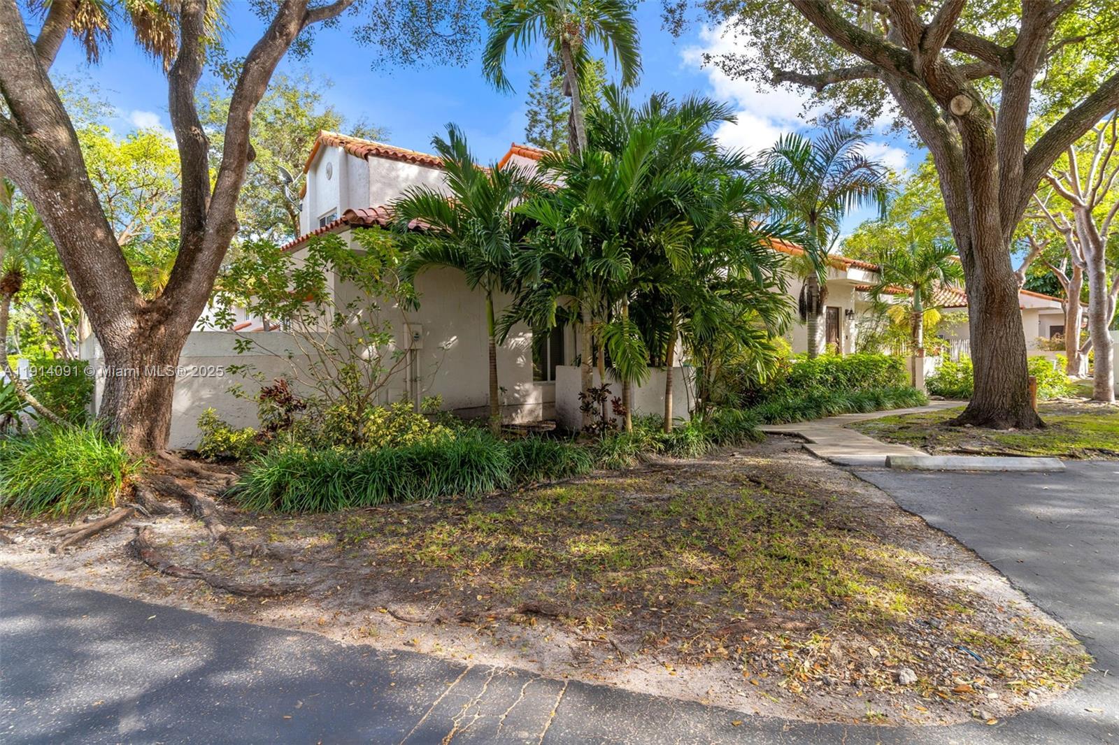 10930 Southwest 75th Street Miami, FL 33173 - Photo 2 of 34 a front view of a house with garden