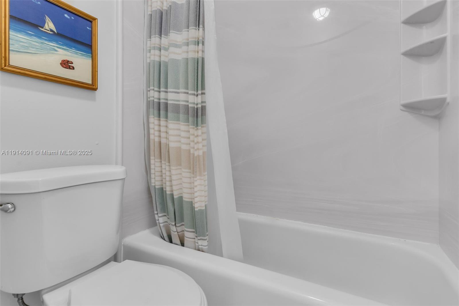 10930 Southwest 75th Street Miami, FL 33173 - Photo 22 of 34 a bathroom with a toilet and a bathtub