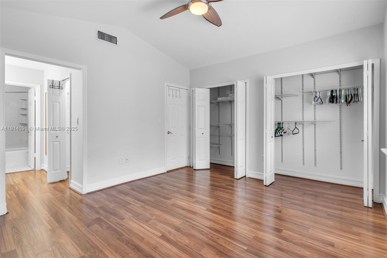10930 Southwest 75th Street Miami, FL 33173 - Photo 24 of 34 an empty room with wooden floor closet and windows