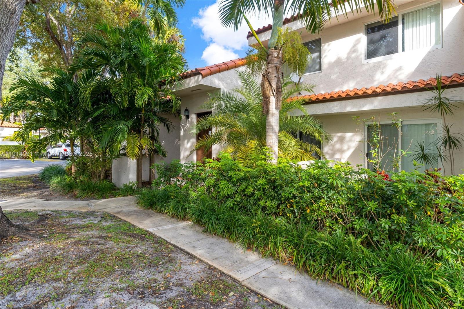 10930 Southwest 75th Street Miami, FL 33173 - Photo 3 of 34 a view of a brick house with a yard