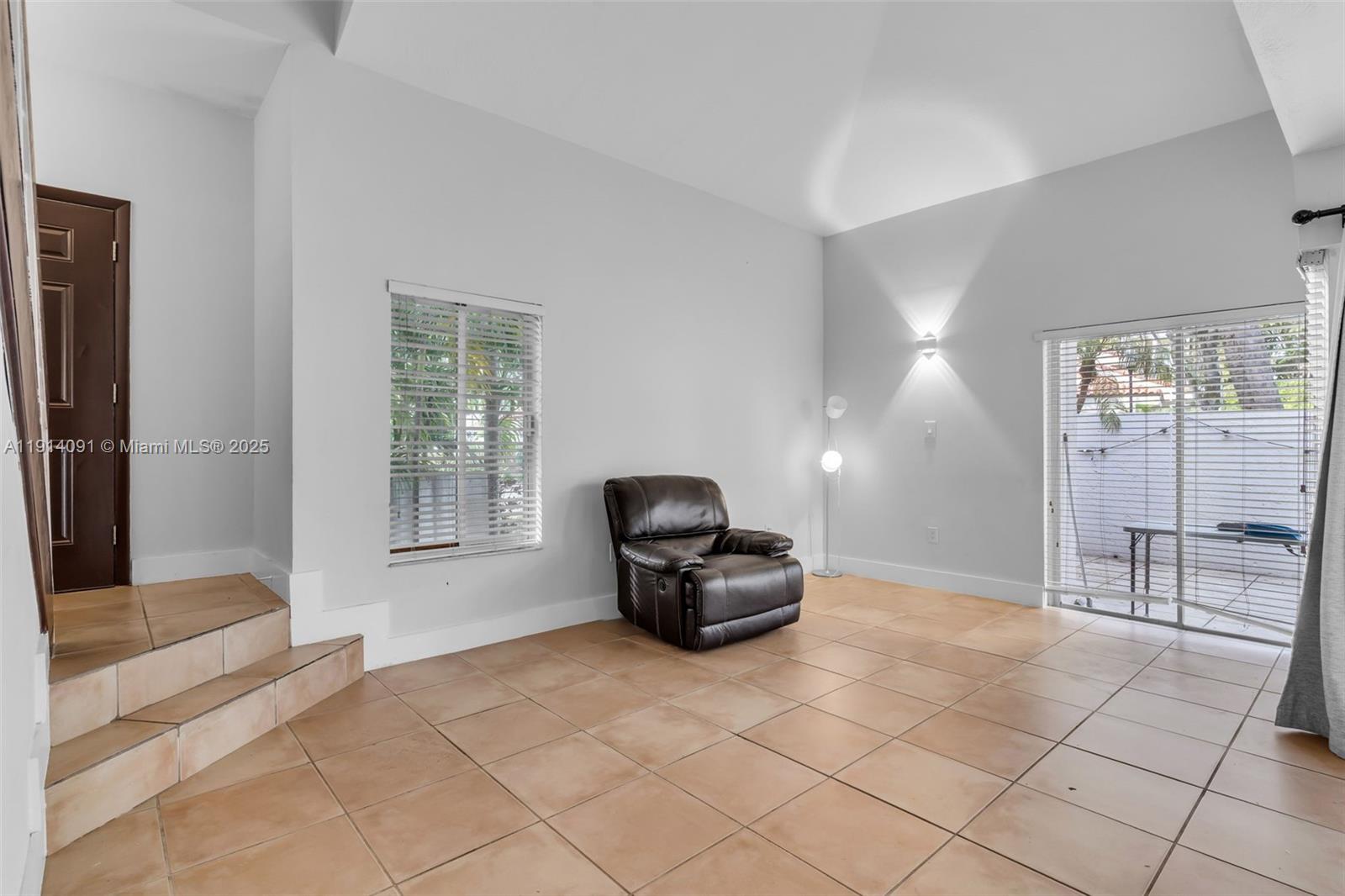 10930 Southwest 75th Street Miami, FL 33173 - Photo 7 of 34 a living room with a couch and a table in it