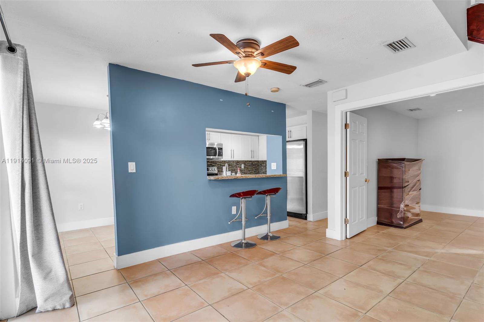 10930 Southwest 75th Street Miami, FL 33173 - Photo 8 of 34 a living room with furniture and a ceiling fan