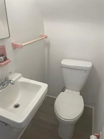 a white toilet sitting next to a bathroom sink